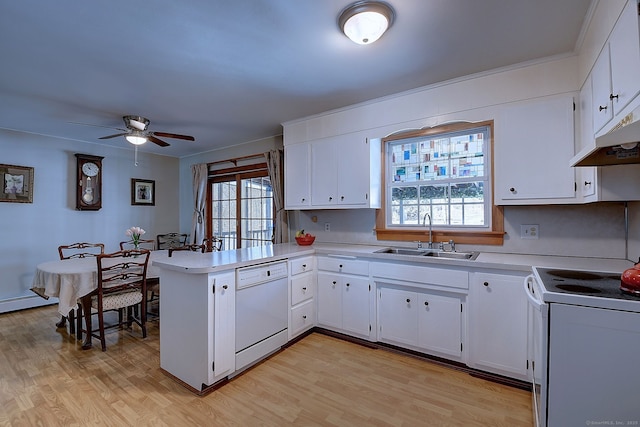 kitchen featuring a sink, white appliances, a peninsula, light countertops, and ceiling fan