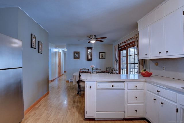 kitchen featuring a ceiling fan, a peninsula, freestanding refrigerator, light countertops, and dishwasher