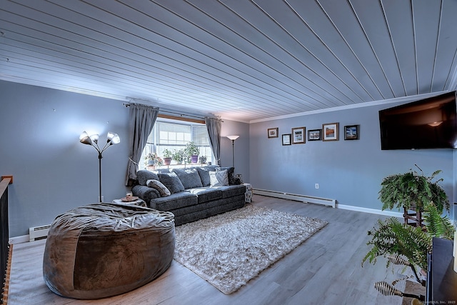 living area featuring baseboard heating, wood finished floors, baseboards, and ornamental molding