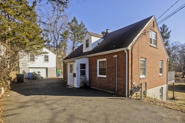 rear view of property featuring brick siding