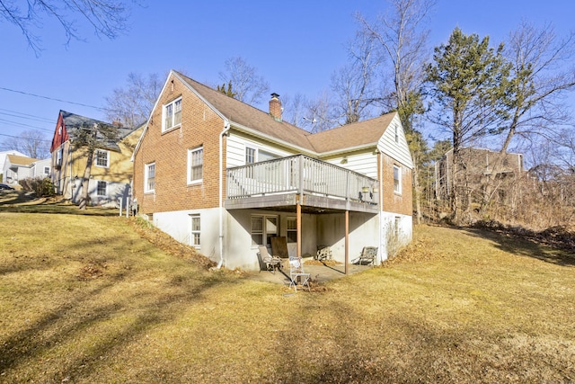 back of house featuring a wooden deck, a lawn, and a chimney