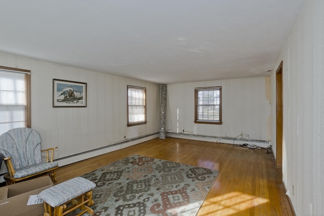 living area featuring baseboard heating and wood finished floors