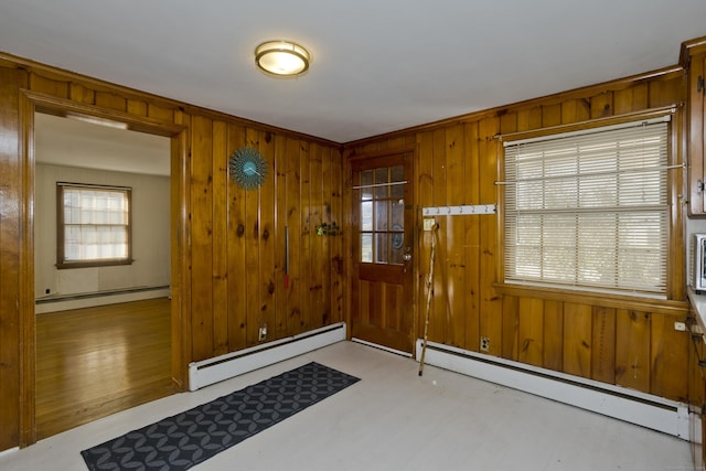 foyer entrance with wood walls and a baseboard radiator