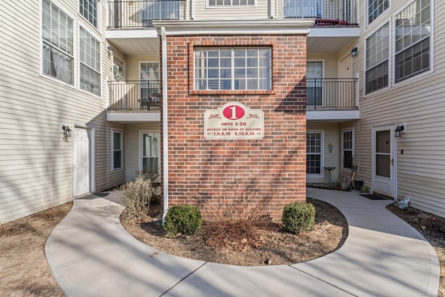 entrance to property featuring brick siding