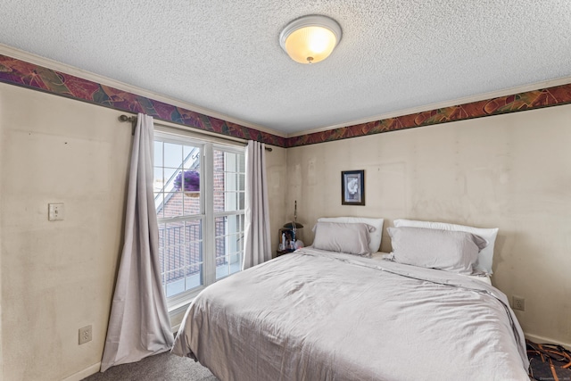 bedroom featuring baseboards and a textured ceiling