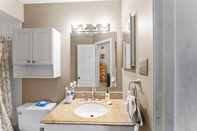 bathroom with vanity, toilet, and a shower with curtain