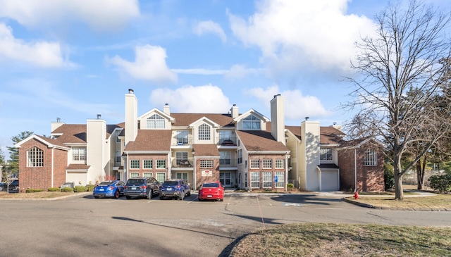 view of property featuring a residential view and uncovered parking