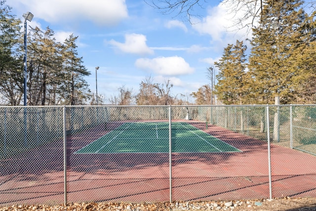 view of sport court featuring fence