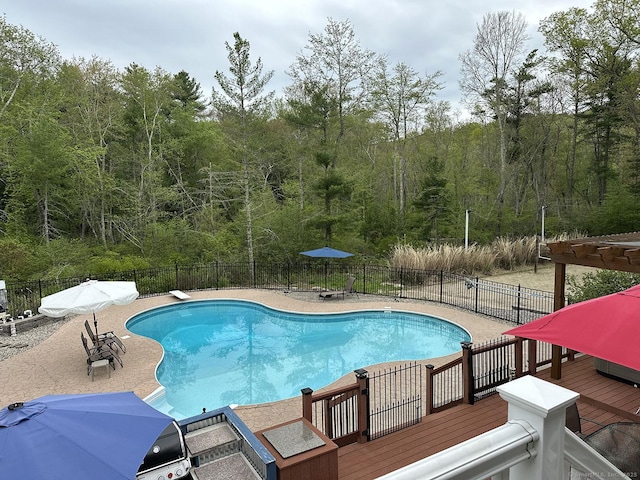105 Mashentuck Rd, Killingly, CT 06239 - view of swimming pool featuring a deck, a wooded view, and a patio area