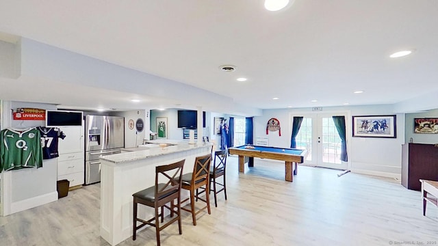 105 Mashentuck Rd, Killingly, CT 06239 - kitchen featuring stainless steel refrigerator with ice dispenser, light wood-style floors, a breakfast bar, white cabinets, and billiards