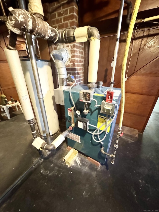 utility room featuring a heating unit and water heater