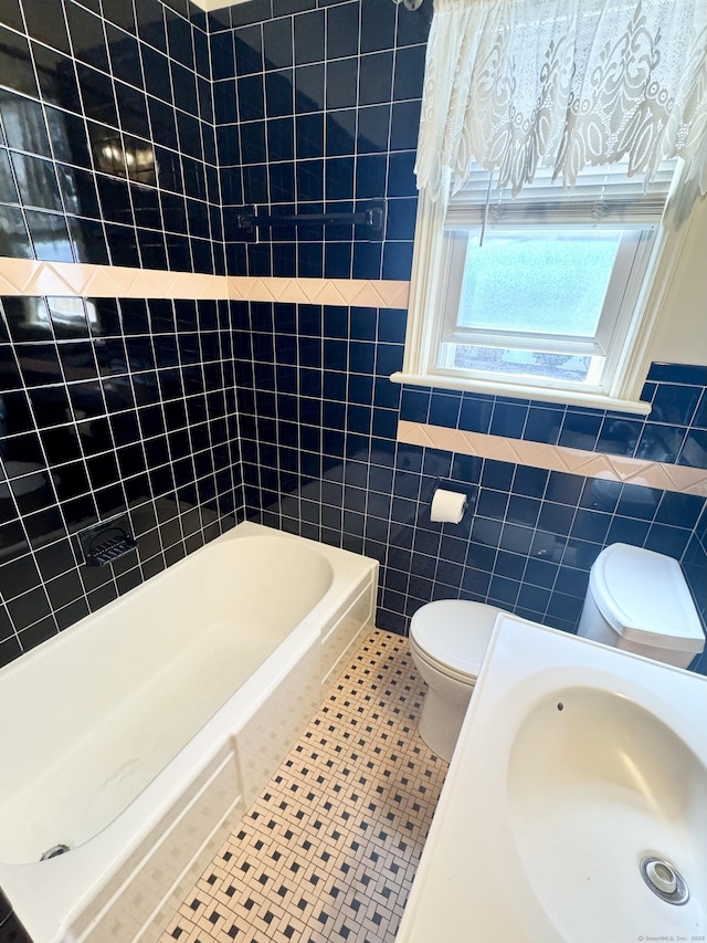 full bathroom with a sink, toilet, tile walls, and tile patterned flooring