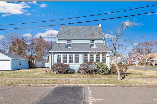 view of front of house featuring a front lawn, fence, roof with shingles, a garage, and a chimney
