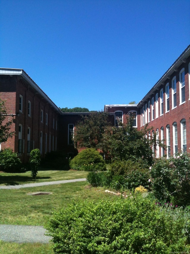 view of home's community with a lawn