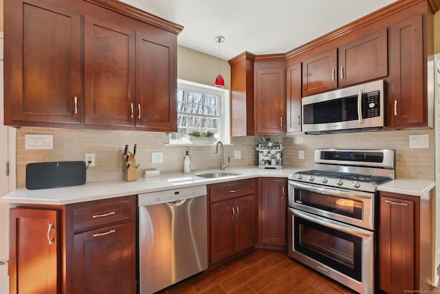 kitchen featuring a sink, appliances with stainless steel finishes, and light countertops