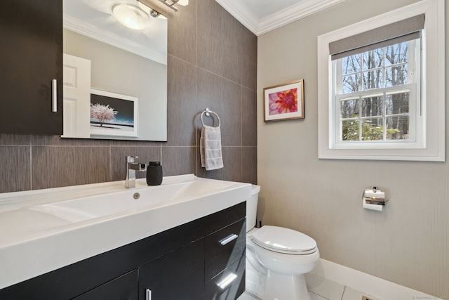 bathroom with vanity, toilet, and crown molding