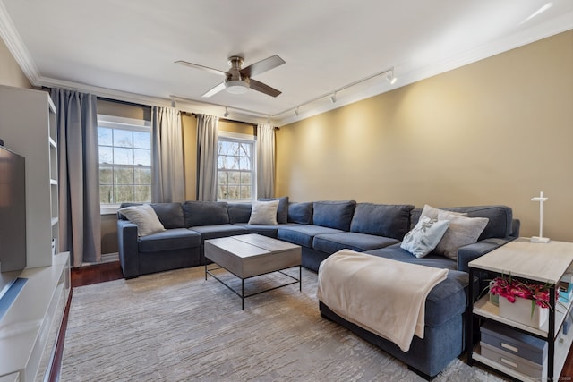 living room featuring crown molding, wood finished floors, and a ceiling fan