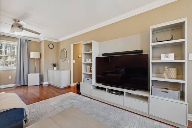 living room with a ceiling fan, crown molding, wood finished floors, and baseboards