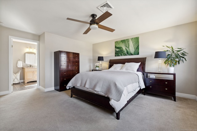 bedroom with visible vents, carpet flooring, ensuite bath, and baseboards