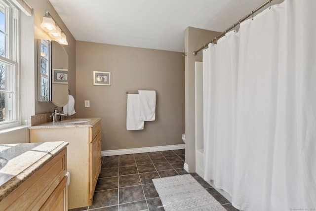 bathroom featuring toilet, curtained shower, tile patterned flooring, baseboards, and vanity