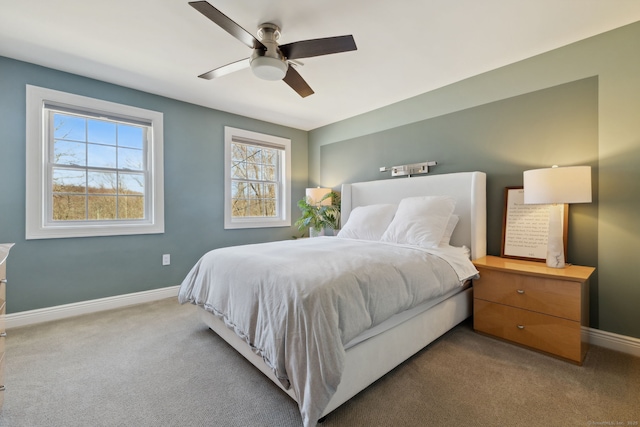 carpeted bedroom featuring a ceiling fan and baseboards