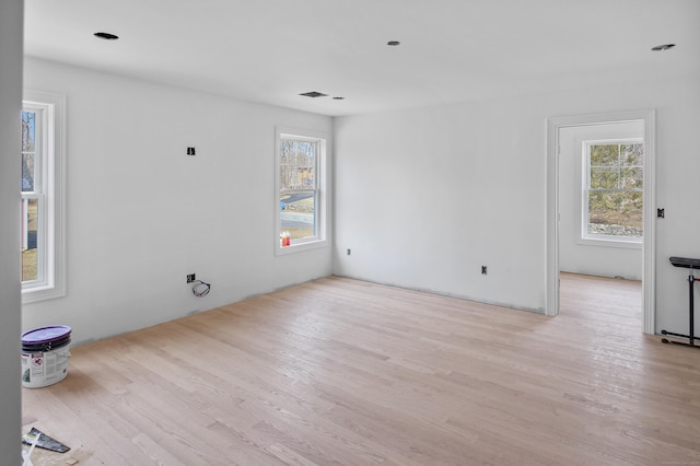 empty room featuring plenty of natural light and wood finished floors