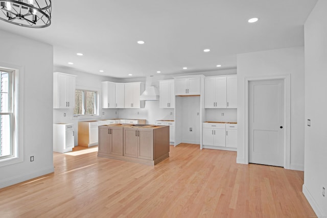 25 S Rd, Bozrah, CT 06334 - kitchen with an inviting chandelier, a center island, baseboards, light wood-style flooring, and custom exhaust hood