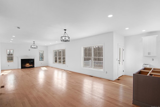 25 S Rd, Bozrah, CT 06334 - unfurnished living room featuring recessed lighting, light wood finished floors, visible vents, baseboards, and a glass covered fireplace