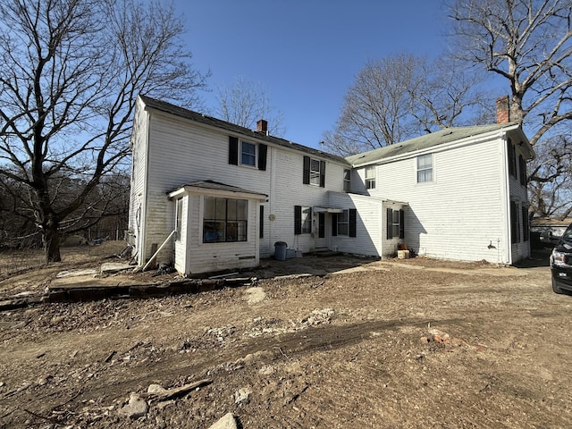 back of property featuring a chimney