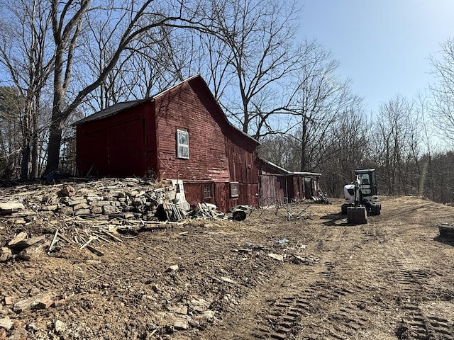 view of side of home with a barn and an outdoor structure