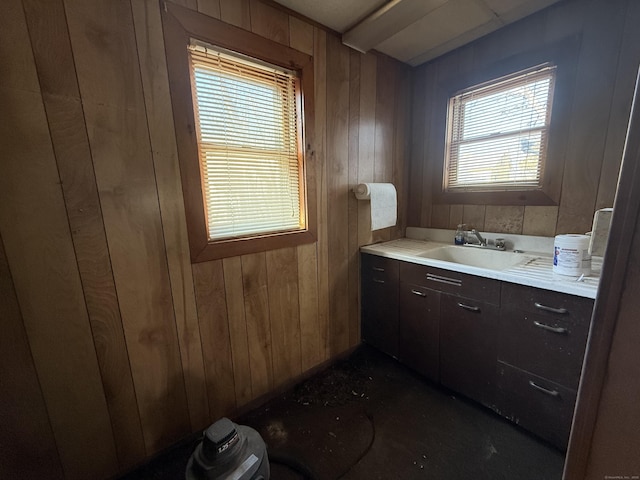 bathroom featuring wooden walls and vanity