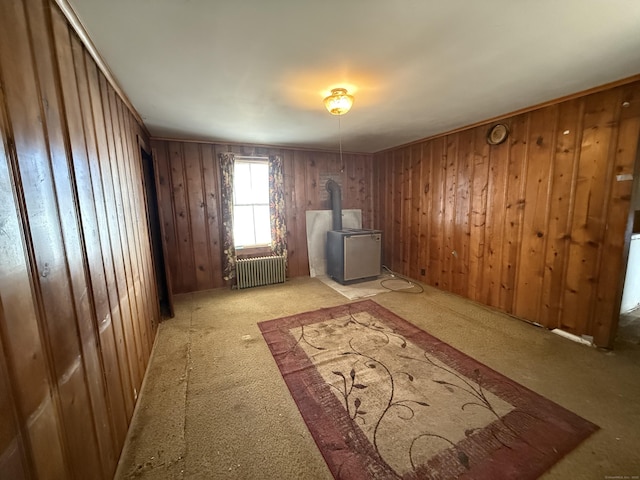 interior space featuring radiator heating unit and a wood stove