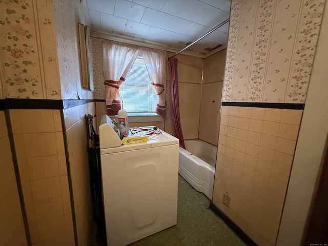 laundry area featuring wallpapered walls, washer / dryer, and tile walls