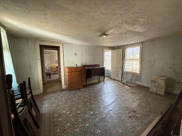 unfurnished bedroom with wallpapered walls and baseboards