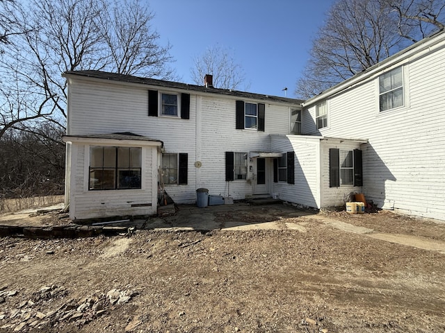 rear view of house featuring entry steps