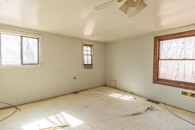 spare room with tile patterned floors, visible vents, and a ceiling fan