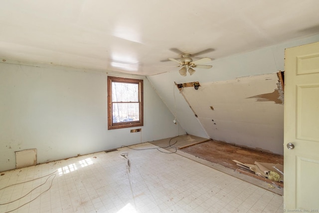 additional living space featuring lofted ceiling and ceiling fan