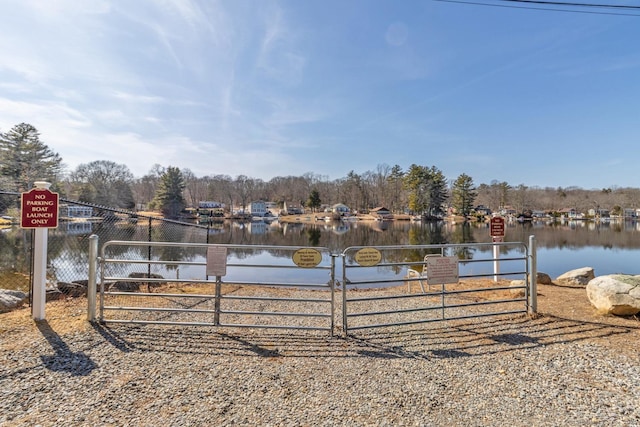 view of yard featuring a gate, fence, and a water view