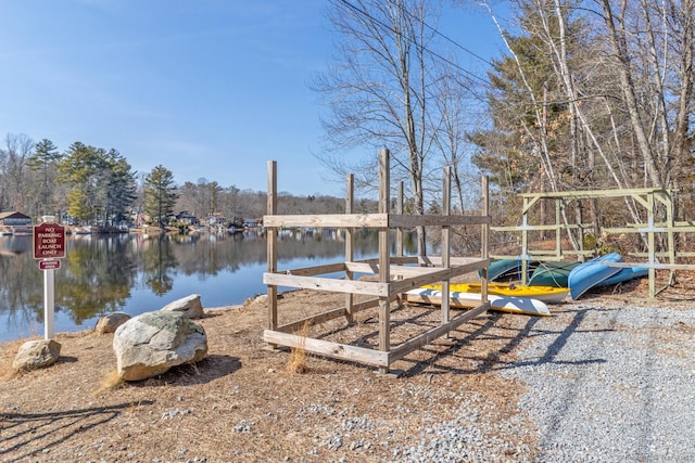 dock area with playground community and a water view