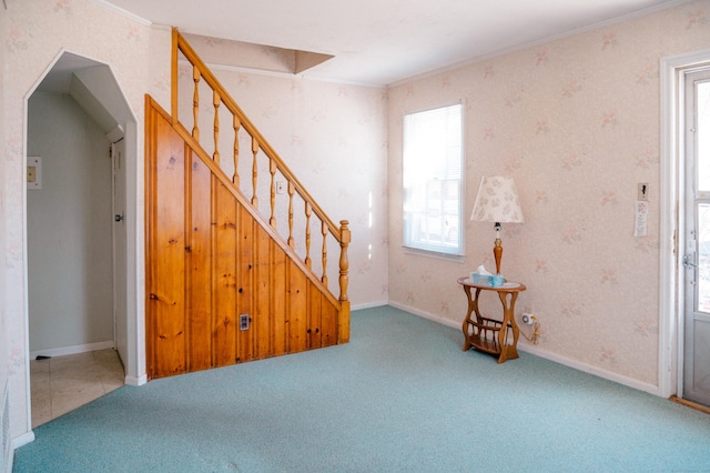 interior space with stairway, ornamental molding, carpet flooring, and wallpapered walls