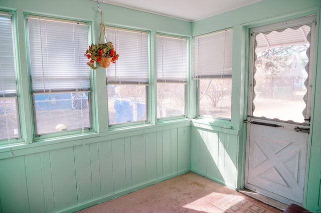 unfurnished sunroom featuring a wealth of natural light