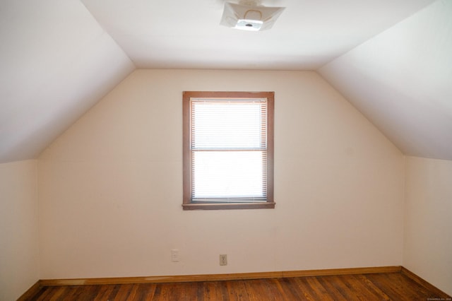 bonus room with baseboards, dark wood-type flooring, and lofted ceiling