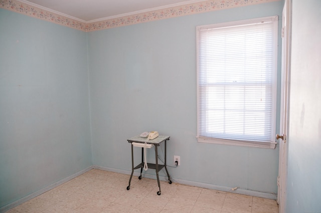 empty room with tile patterned floors and crown molding