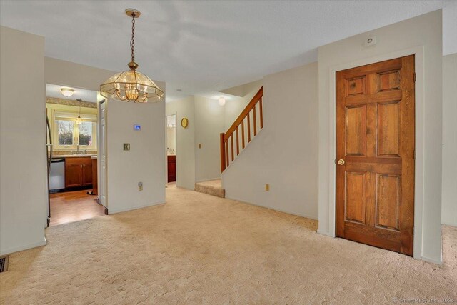827 Oronoke Rd Apt 2-11, Waterbury, CT 06708 - interior space with stairs, a notable chandelier, a sink, and light carpet