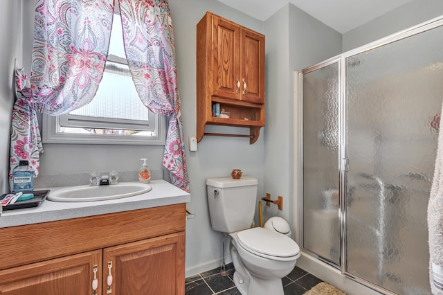 bathroom with tile patterned floors, toilet, a stall shower, and vanity