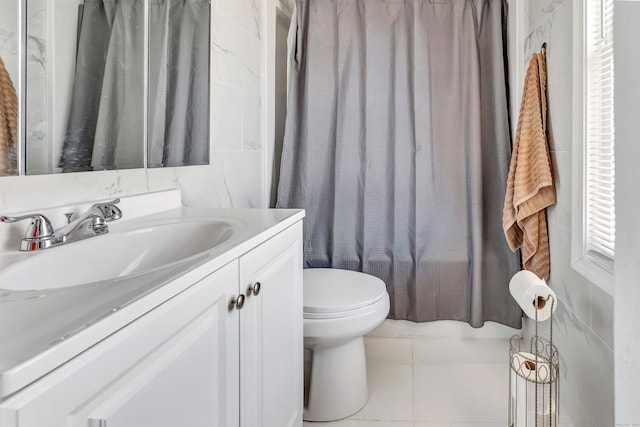 bathroom featuring curtained shower, toilet, vanity, and tile patterned flooring