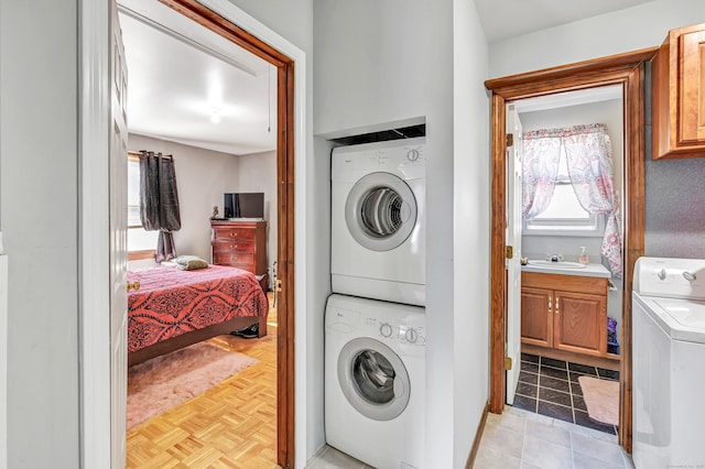 laundry room featuring a sink, laundry area, and stacked washing maching and dryer