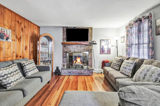 living area with wood finished floors and a fireplace