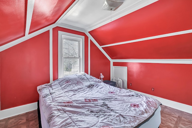 bedroom with baseboards and vaulted ceiling