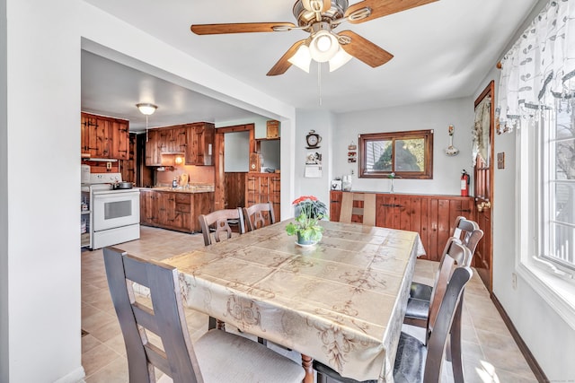 dining space featuring ceiling fan and light tile patterned flooring